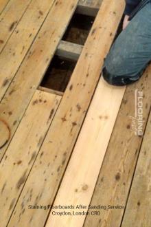 Staining floorboards after sanding service in Croydon